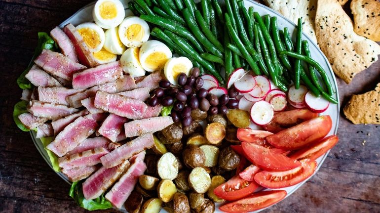 Slices of fresh tuna, roasted potato, radishes, fresh tomatoes, blanched...