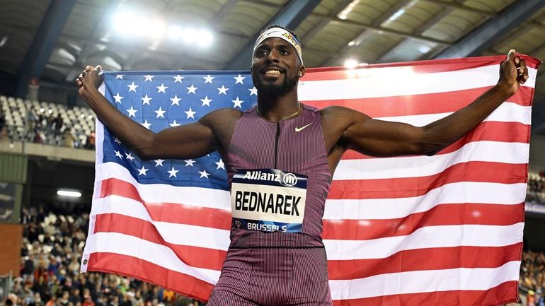 Kenneth Bednarek, of the United States, poses after winning the...