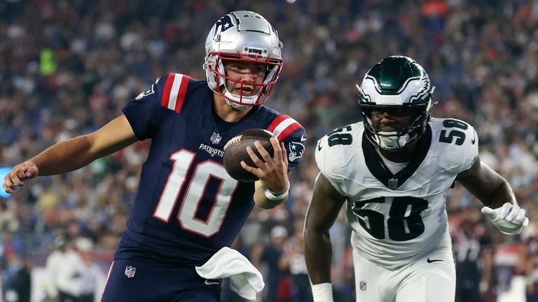 New England Patriots quarterback Drake Maye (10) carries the ball...