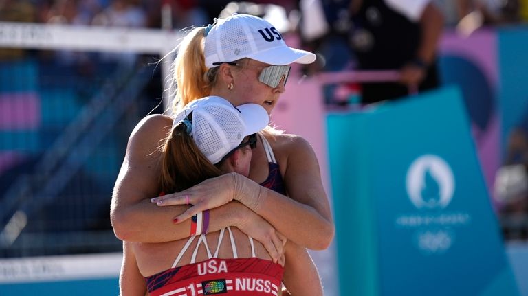 United States' Taryn Kloth, top, and Kristen Nuss hug after...