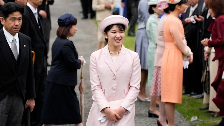 FILE- Japan's Princess Aiko greets guests during the spring garden...