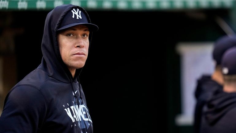 The Yankees' Aaron Judge watches from the dugout during the...