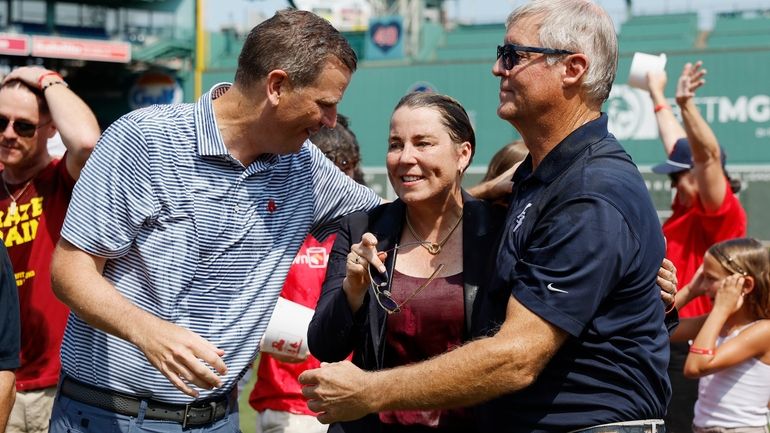 Boston Red Sox president and CEO Sam Kennedy, left, talks...