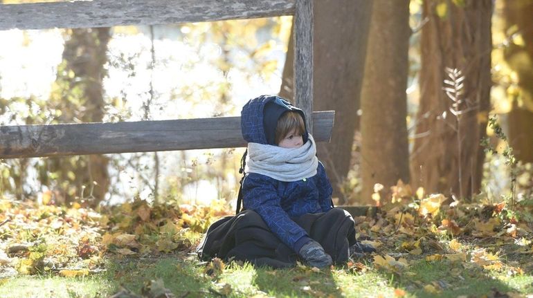 Henry Martin, 5, under the watchfull eyes of his grandparents,...