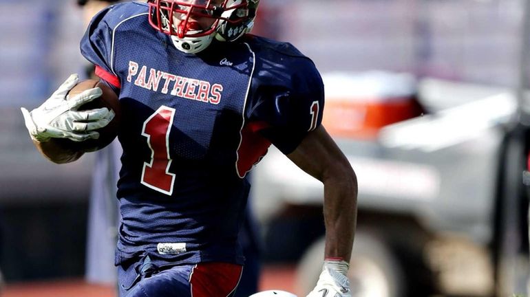 Miller Place running back Adin Greenfield breaks the tackle attempt...