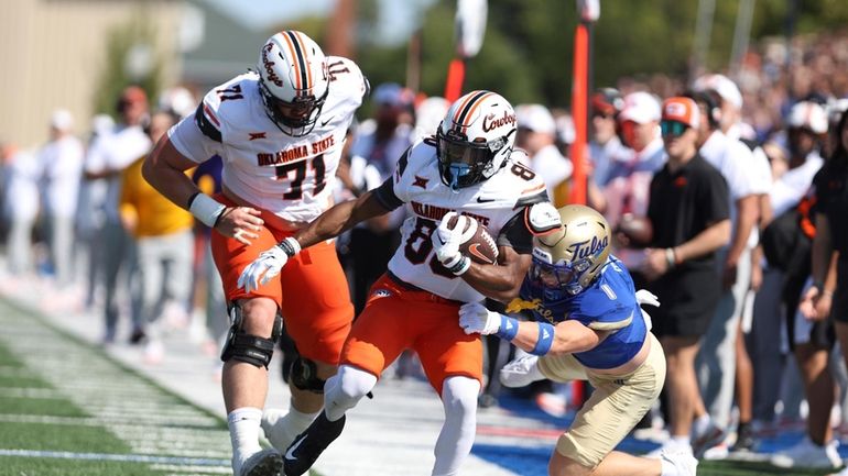 Oklahoma State wide receiver Brennan Presley (80) is tackled by...