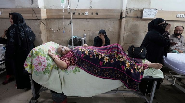 A patient suffering from heatstroke receives treatment at a hospital...