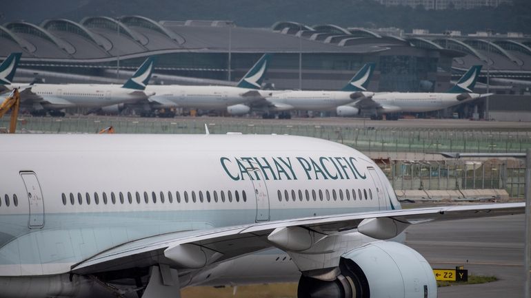 A Cathay Pacific airplane taxis at Hong Kong International Airport...