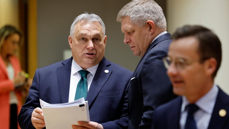 Slovakia's Prime Minister Robert Fico, right, talks to Hungary's Prime...