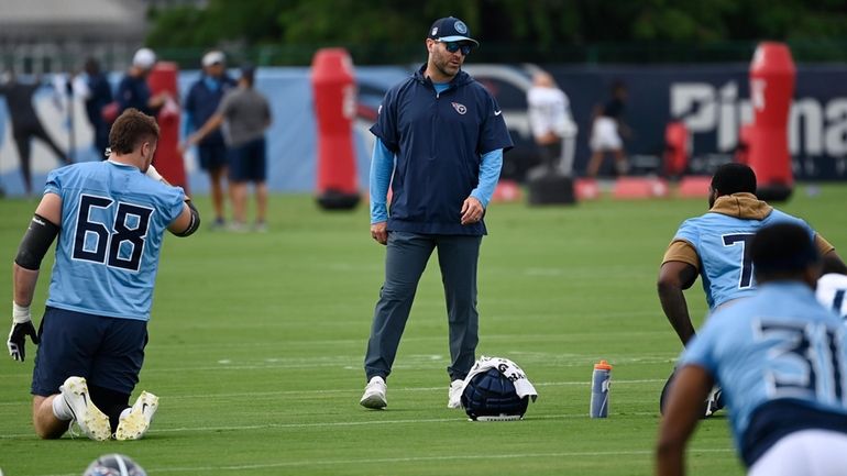 Tennessee Titans head coach Brian Callahan talks to his players...