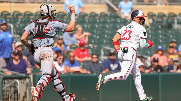 Minnesota Twins' Royce Lewis (23) is chased in a rundown...