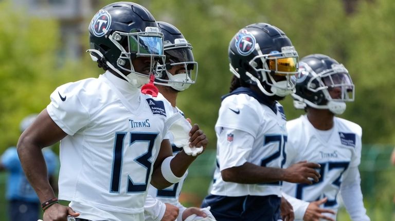 Tennessee Titans cornerback Chidobe Awuzie (13) runs with teammates during...