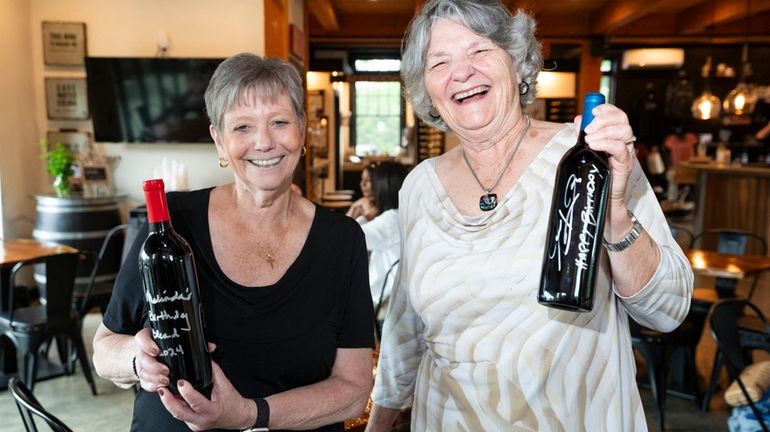 Barbara Russell of Bayport, left, and Melinda Topping of Riverhead with the wine they created...