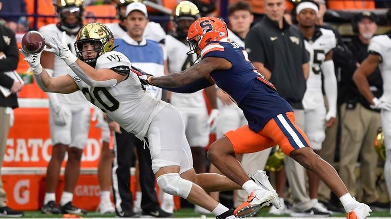 Wake Forest tight end Cameron Hite, left, catches a pass...