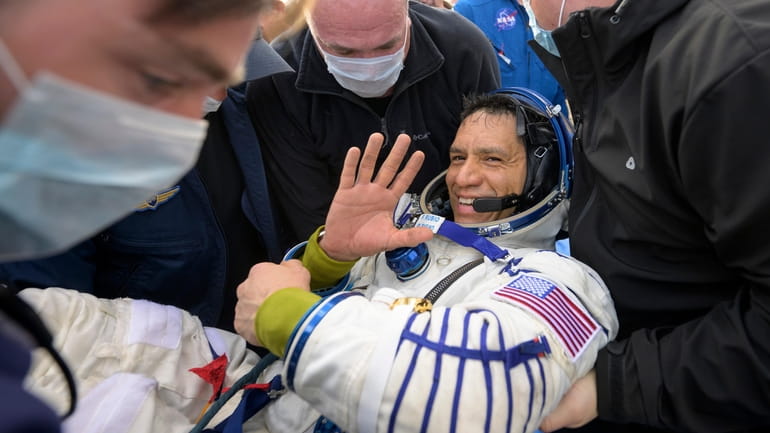 NASA astronaut Frank Rubio is helped out of the Soyuz...