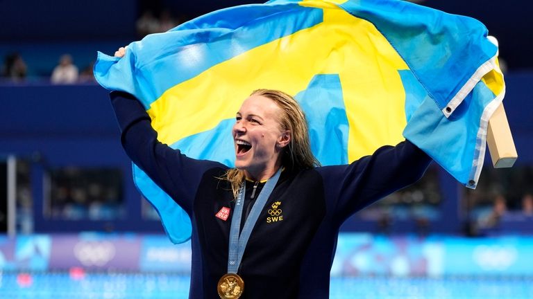 Gold medalist Sarah Sjoestroem, of Sweden, poses after the women's...