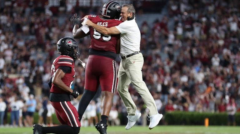 South Carolina head coach Shane Beamer celebrates a fumble recovery...