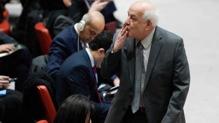 Riyad Mansour, Palestinian Ambassador to the United Nations, blows a...