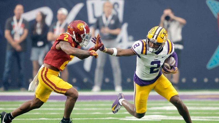 LSU wide receiver Kyren Lacy, right, tries to fend off...