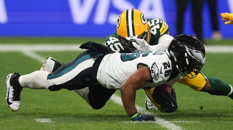 Philadelphia Eagles running back Saquon Barkley (26) is tackled by...