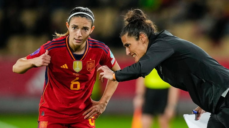 Spain's coach Montserrat Tome, right, gives instructions to Spain's Aitana...
