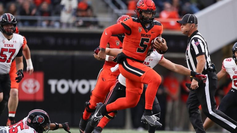 Oregon State quarterback DJ Uiagalelei (5) dodges Utah cornerback Tao...