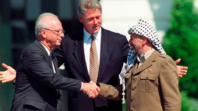 Israeli Prime Minister Yitzhak Rabin, left, and Palestinian leader Yasser...