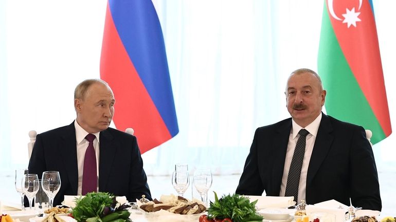 Russian President Vladimir Putin, left, and Azerbaijani President Ilham Aliyev...