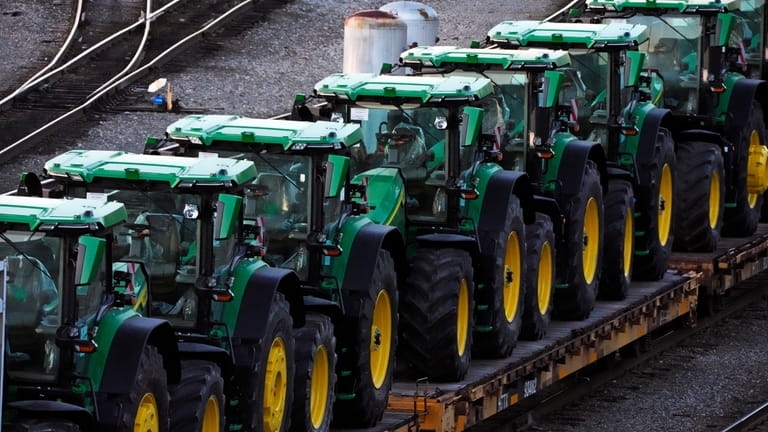 A consist of John Deere tractors sit in Norfolk Southern's...