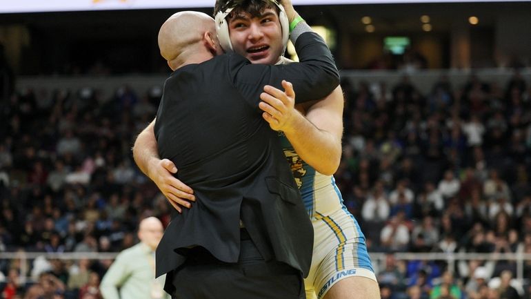 Frankie Volpe Hauppauge celebrates the win with his coach after...