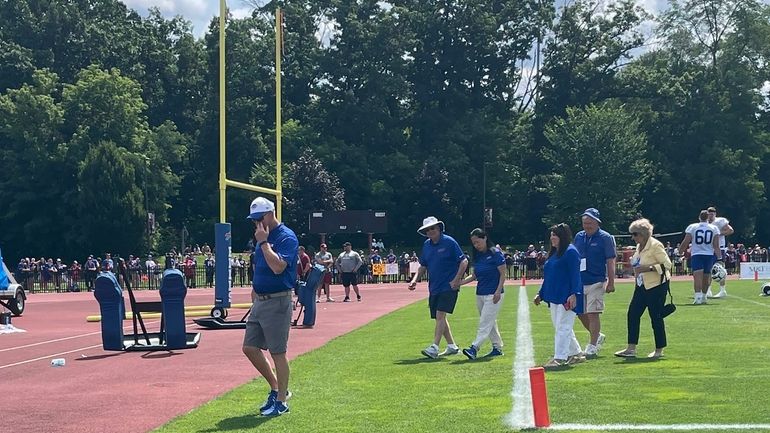 Buffalo Bills owner Terry Pegula holds his wife Kim Pegula's...