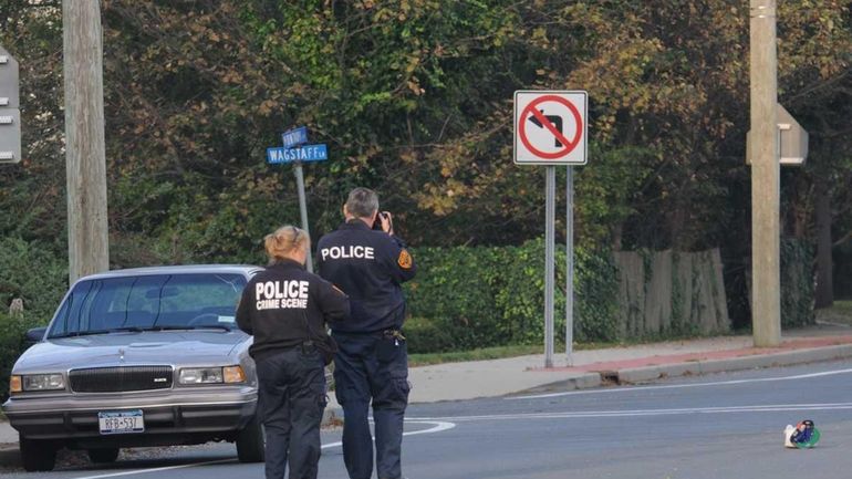 Police investigate a crash near Montauk Highway in West Islip...