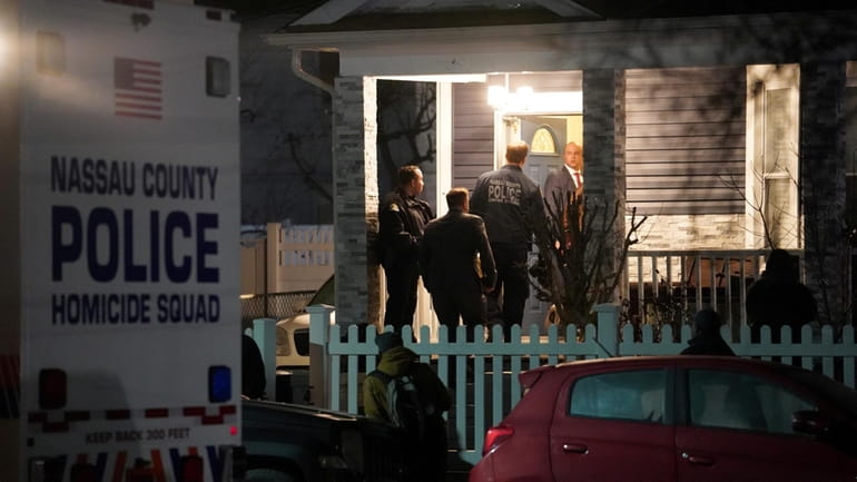 Nassau police at the Maryland Avenue home in Hempstead Monday...
