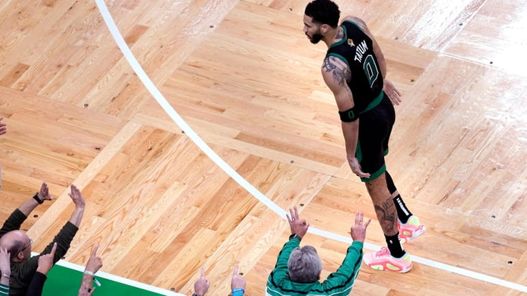 Fans celebrate after a basket by Boston Celtics forward Jayson...