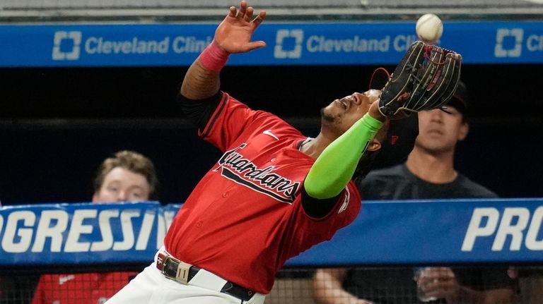 Cleveland Guardians third baseman Jose Ramirez catches a foul ball...