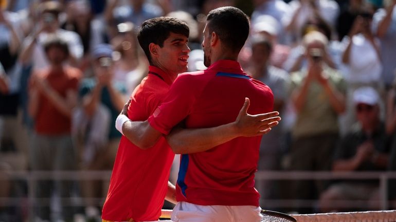 Serbia's Novak Djokovic and Spain's Carlos Alcaraz great each other...