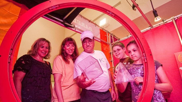 Cindy Lawrence, second from left, helps Lisa, Bob, Kyle and...