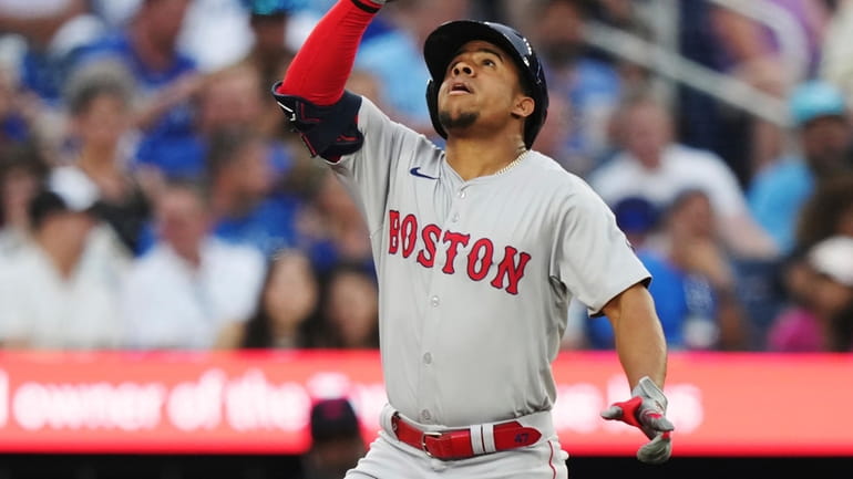 Boston Red Sox's Enmanuel Valdez celebrates his solo home run...