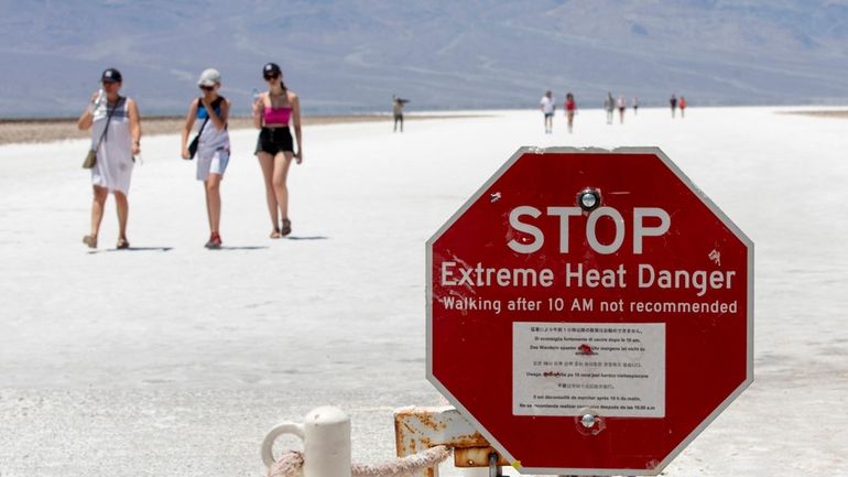 A stop sign warns tourists of extreme heat at Badwater...