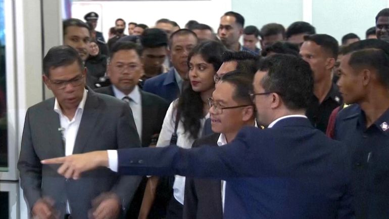 This grab taken from a video shows Malaysian officials receiving...