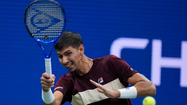 Alexei Popyrin, of Australia, returns a shot to Novak Djokovic,...