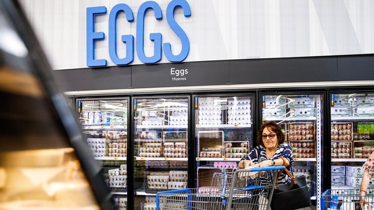 A woman buys eggs at a Walmart Superstore in Secaucus,...