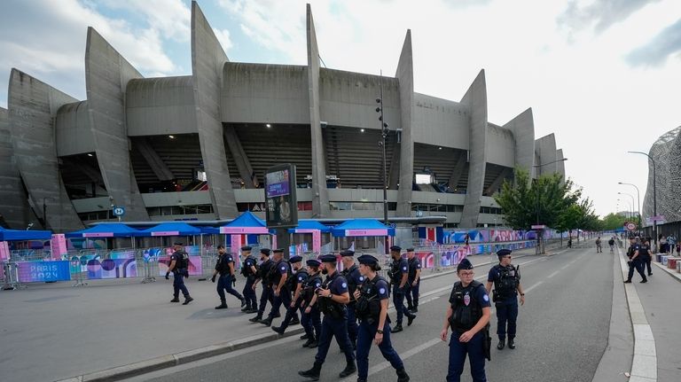 Police clear the streets outside the stadium ahead of the...