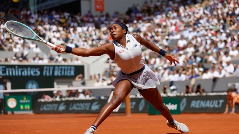 Coco Gauff of the U.S. plays a shot against Poland's...