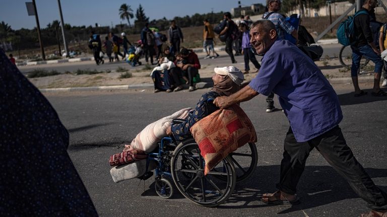 Palestinians flee to the southern Gaza Strip on Salah al-Din...