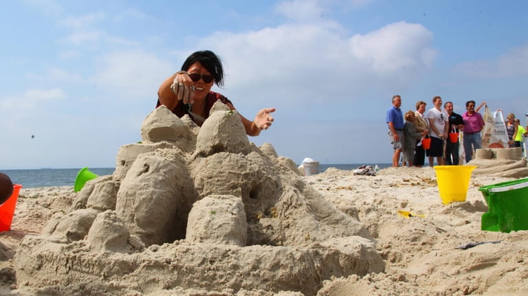 Minnae Chae builds a sand castle at Town Park at...