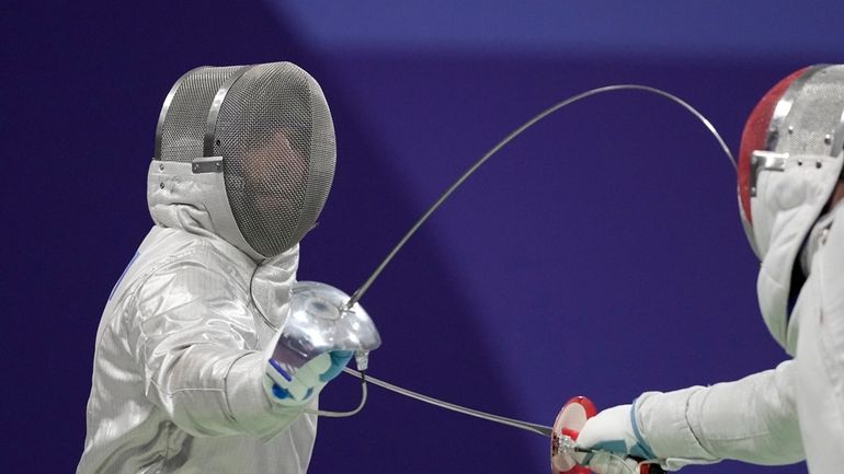 Hungary's Aron Szilagyi, left, and Canada's Fares Arfa compete in...