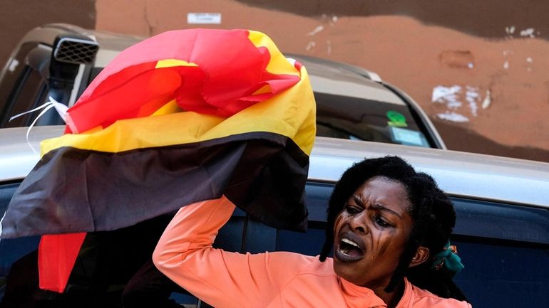 A protester holding a her country national flag during the...