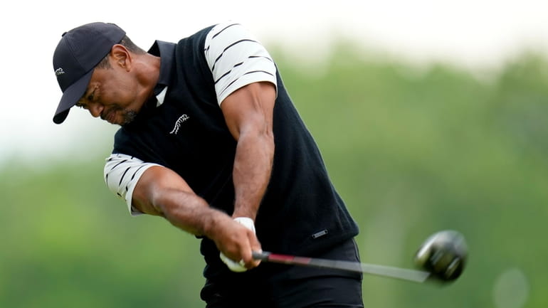 Tiger Woods hits his tee shot on the fifth hole...