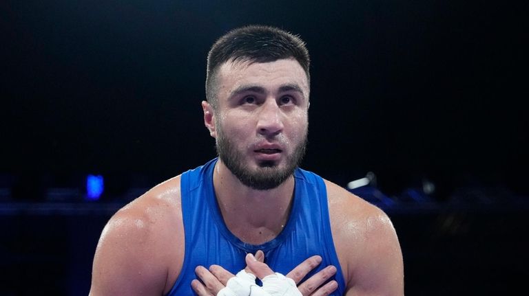 Uzbekistan's Bakhodir Jalolov celebrates after defeating Norway's Omar Shiha in...